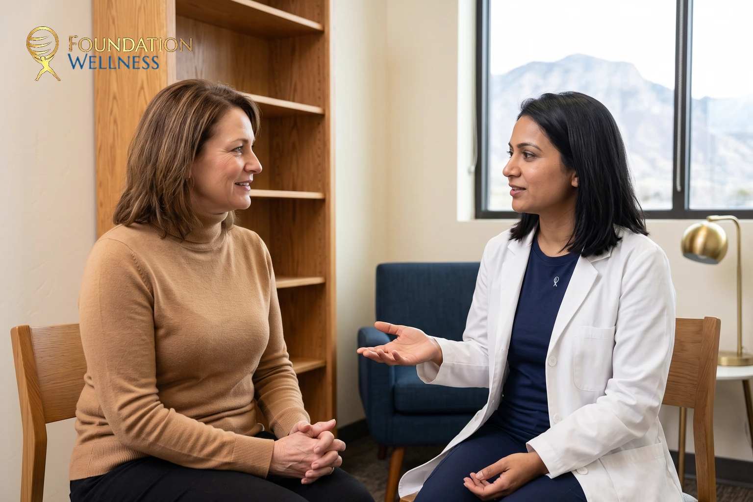 A woman in a camel turtleneck listening as a physician in a white coat explains something with an open hand beside oak shelving